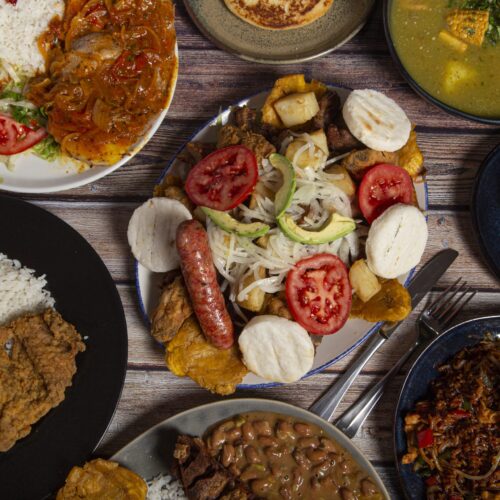 A top view shot of various dishes of Colombian cuisine on the restaurant table